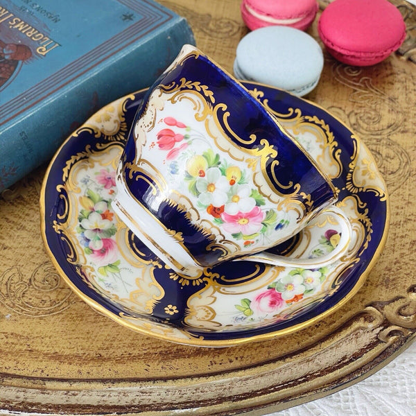 An antique Coalport cup and saucer, handpainted flowers, cobalt blue