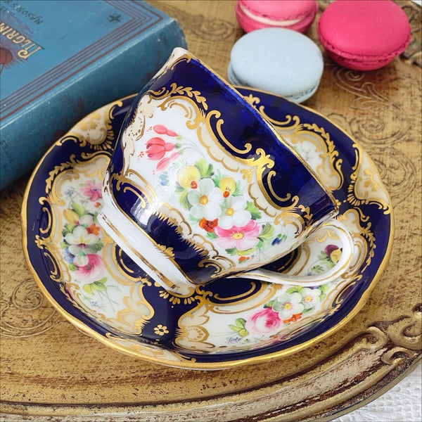 An antique Coalport cup and saucer, handpainted flowers, cobalt blue