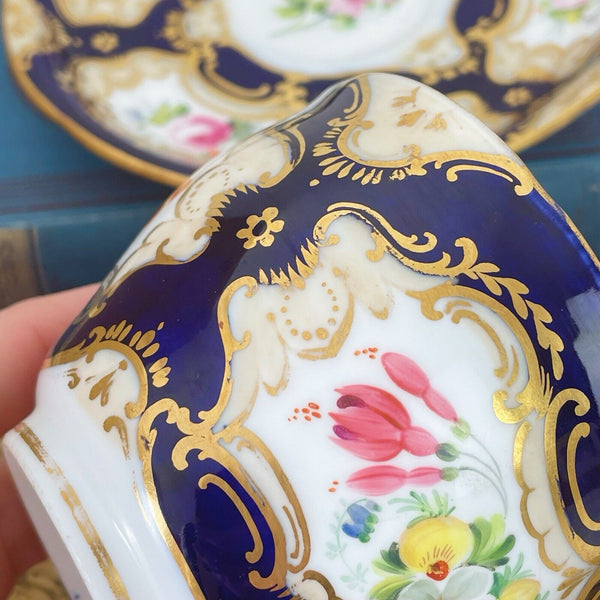 An antique Coalport cup and saucer, handpainted flowers, cobalt blue