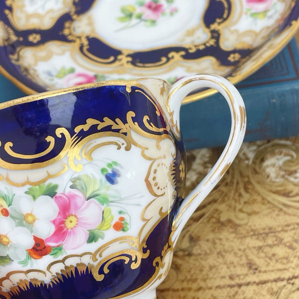 An antique Coalport cup and saucer, handpainted flowers, cobalt blue