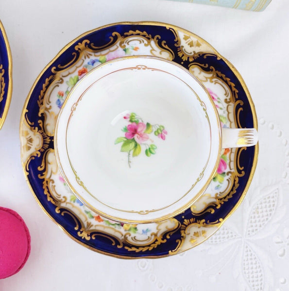 Pair of antique Coalport cups and saucer, handpainted flowers, cobalt blue