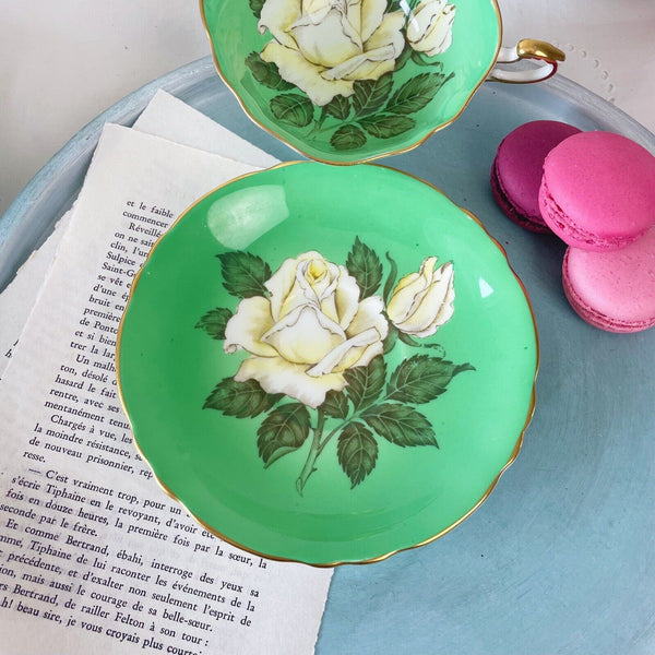 Vintage Paragon cabinet cup duo, green ground, floating cabbage rose