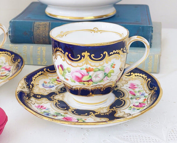 Pair of antique Coalport cups and saucer, handpainted flowers, cobalt blue