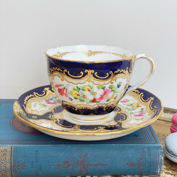 An antique Coalport cup and saucer, handpainted flowers, cobalt blue