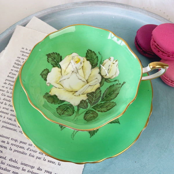 Vintage Paragon cabinet cup duo, green ground, floating cabbage rose