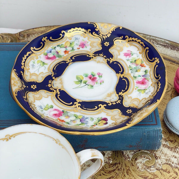 An antique Coalport cup and saucer, handpainted flowers, cobalt blue