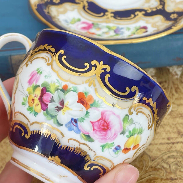 An antique Coalport cup and saucer, handpainted flowers, cobalt blue