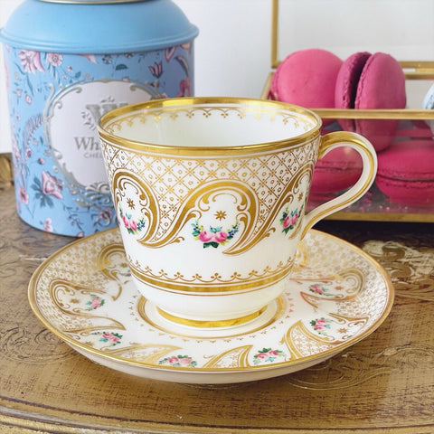 Brown Westhead Moore teacup and saucer set, gilded and handpainted rose swags