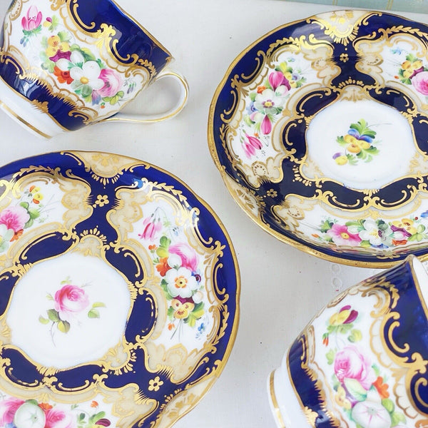 Pair of antique Coalport cups and saucer, handpainted flowers, cobalt blue