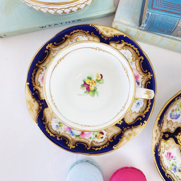 Pair of antique Coalport cups and saucer, handpainted flowers, cobalt blue